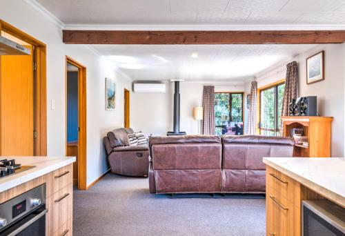 a kitchen and a living room with a couch at 7b Denby Place in Hanmer Springs