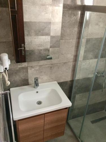 a bathroom with a sink and a glass shower at Orya Aparts in Gümbet