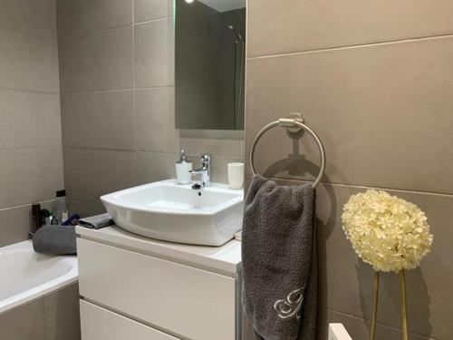 a bathroom with a sink and a mirror and a towel at Luxury Aparment in Madrid in Madrid