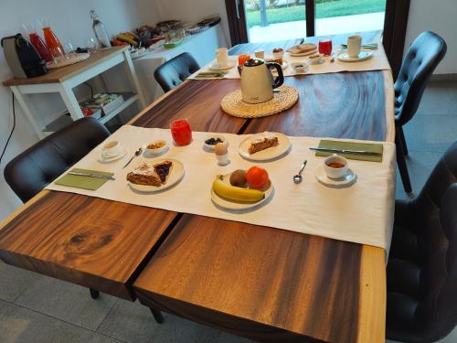 a table with plates of food on it at B&B Villa Letizia in San Vito Rimini