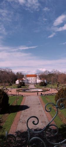 a park with benches and a building in the background at Apartman 21 Banja Koviljača in Banja Koviljača