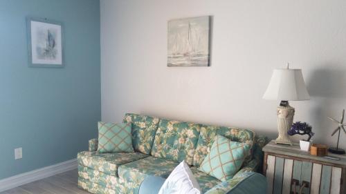 a living room with a couch and a lamp at 2BR/1BA Sienna Park, Sarasota Fl in Sarasota