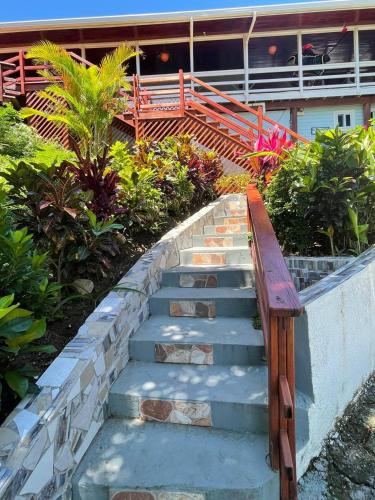 a set of stairs with a wooden bench on top at Hotel and Dive Center Roatan Yacht Club in Roatán