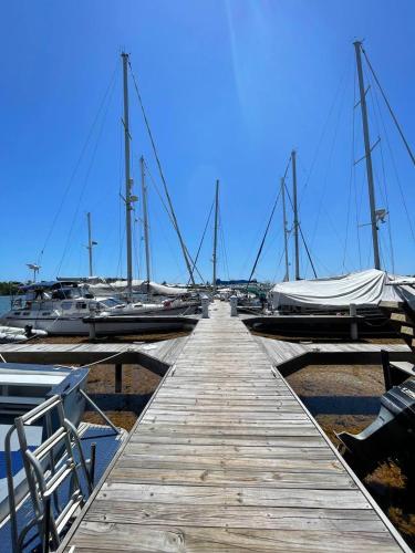a wooden dock with boats in a marina at Hotel and Dive Center Roatan Yacht Club in Roatán