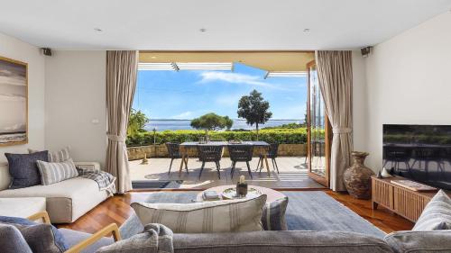 a living room with a view of the ocean at Mariners One 1 at 39 Victoria Parade in Nelson Bay