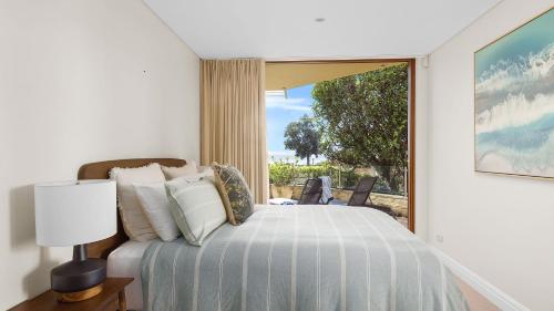 - une chambre avec un lit et une grande fenêtre dans l'établissement Mariners One 1 at 39 Victoria Parade, à Nelson Bay