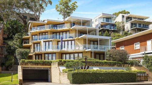 an apartment building with a garage in front of it at Mariners One 1 at 39 Victoria Parade in Nelson Bay