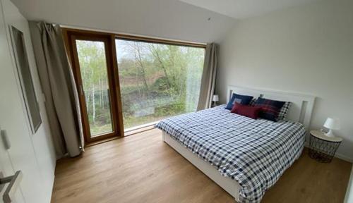 a bedroom with a bed and a large window at Luxury Duplex in Luxembourg Center Free Parking 5 min walk to the tram in Luxembourg