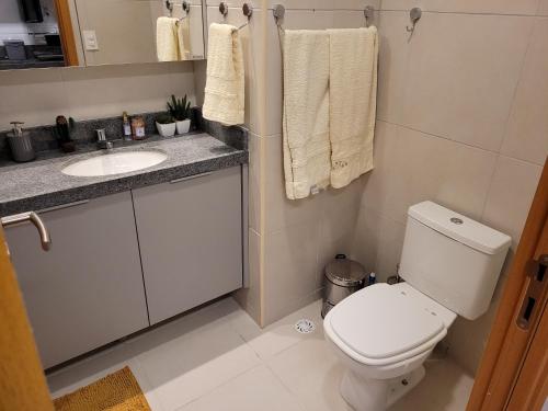 a bathroom with a white toilet and a sink at Praia dos Carneiros Flat 120-CM Eco Resort - ao lado da igrejinha in Tamandaré