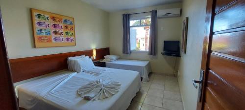 a small bedroom with a bed and a window at Praia Boulevard Flat Porto Bahia in Porto Seguro