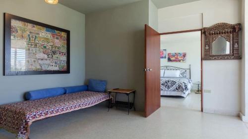 a room with a bed and a door to a bedroom at La Esmeralda PR in San Juan