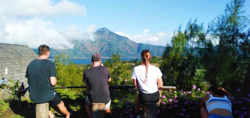 a group of people looking out at the mountains at Bali Cottages Lake View in Kintamani