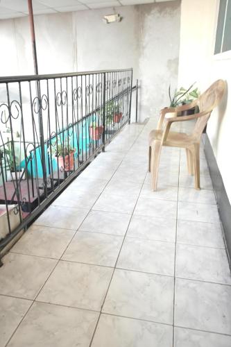 a chair sitting on top of a tile floor at Hostal Nicaragua Guest House in Managua