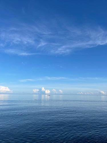 a large body of water with a blue sky and clouds at Lombok Private Villa Estate in Ketapang