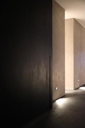 an open door in a dark room with lights at Lombok Private Villa Estate in Ketapang