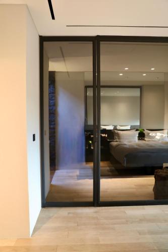 a bedroom with a bed and a sliding glass door at Lombok Private Villa Estate in Ketapang