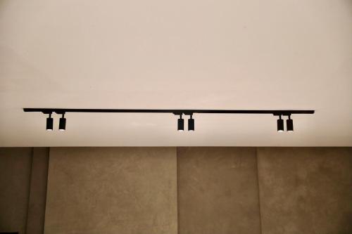 a shelf on a ceiling with three lights on it at Lombok Private Villa Estate in Ketapang