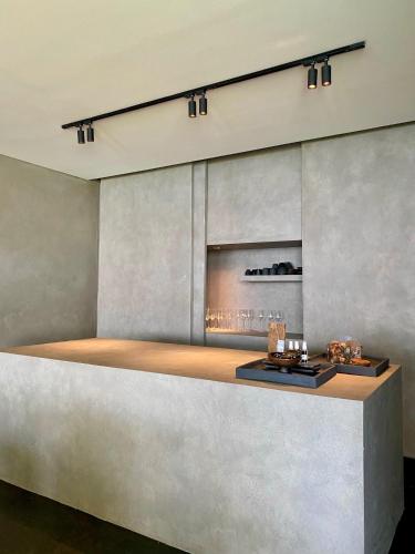 a fireplace in a room with a concrete wall at Lombok Private Villa Estate in Ketapang