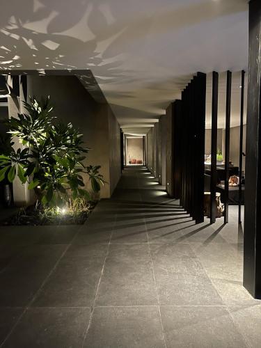 a hallway of a building with plants on the floor at Lombok Private Villa Estate in Ketapang