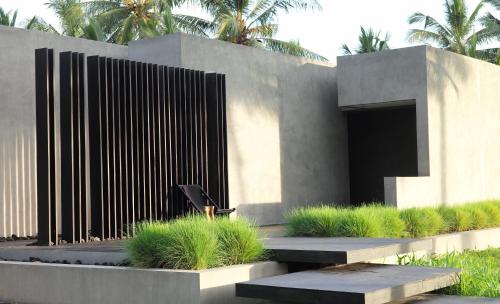 a chair sitting in front of a fence at Lombok Private Villa Estate in Ketapang