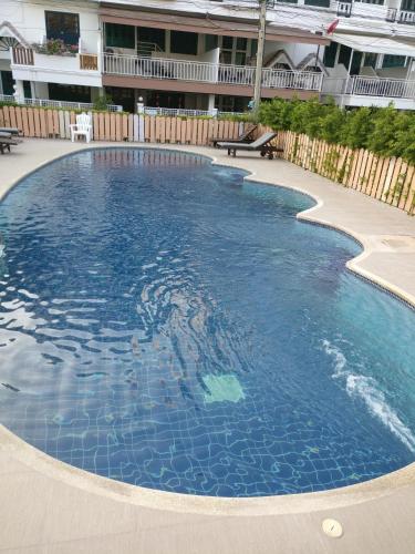 a large swimming pool with blue water at Green Papaya Villa in Hua Hin