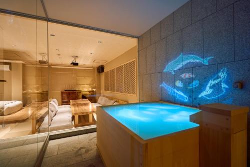 a bathroom with a blue tub in a room at KONJAKUSO Osaka Tempozan "IKESU" Projection M apping SPA "TAKADORO" Wheel View in Osaka