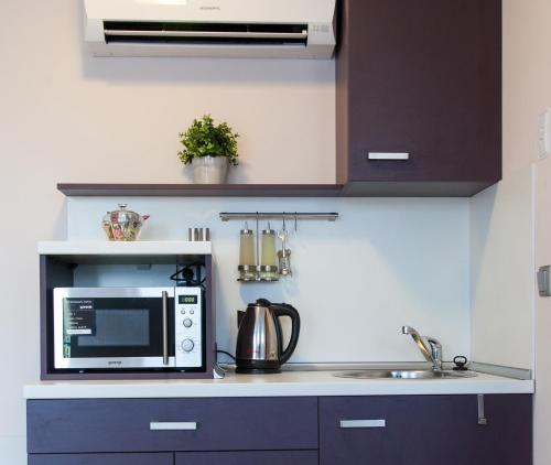 a kitchen with a microwave and a sink at Sky Apartments in Blagoevgrad
