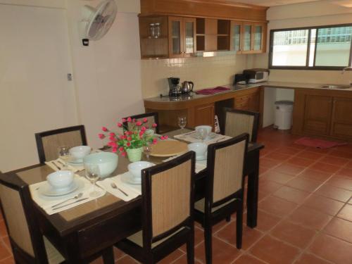 a dining room with a table and chairs in a kitchen at Green Papaya Villa in Hua Hin