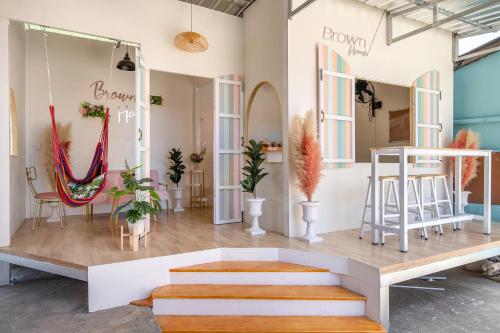 a room with chairs and a table and some plants at Brown Home Sattahip @ 19 in Sattahip