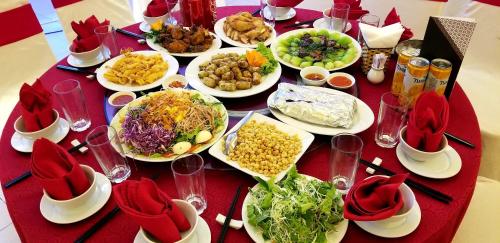 a table with plates of food on a red table at Muong Thanh Thanh Nien Vinh in Vinh