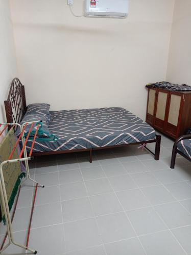 a room with a bed and a chair and a table at Bonda Guesthouse III in Paka