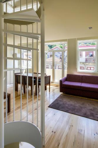 a living room with a couch and a table at PATH Bonjardim Apartments in Porto