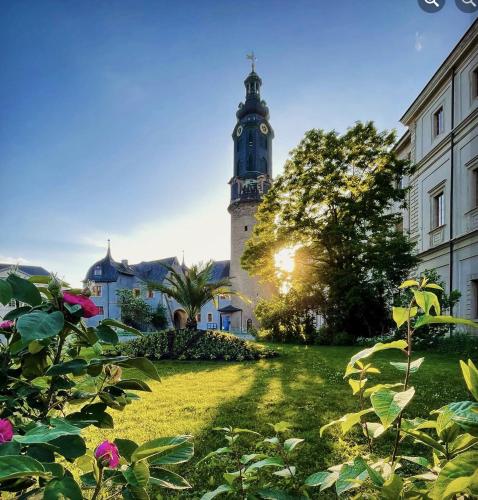 a building with a clock tower in the distance at Boutique-Hotel Amalienhof in Weimar
