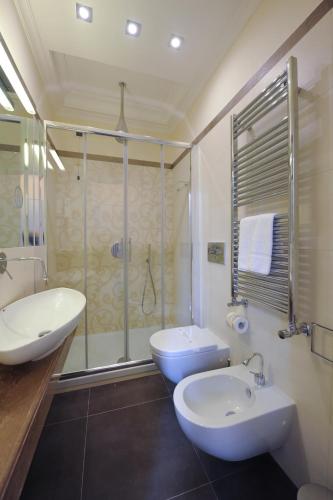 a bathroom with a sink and a toilet and a shower at Villa Zaccardi in Rome