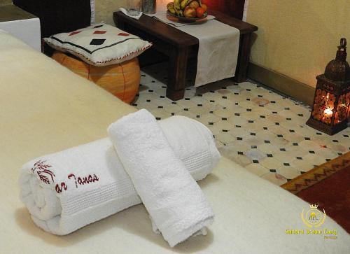 dos rollos de papel higiénico sentados en una cama en Room in Guest room - Luxury Desert Camp - Merzouga, en Tisserdmine
