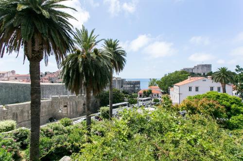 a view of a city with palm trees at Rooms Posat in Dubrovnik