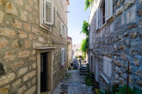an alley in an old town with buildings at Apartment Domix in Dubrovnik