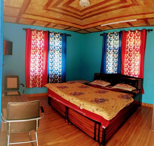 a bedroom with a bed and a chair in it at Farmvilla Homestay in Kalpa
