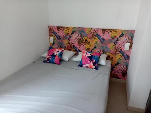 a small bedroom with a bed with a floral wallpaper at T3 vue exceptionnelle avec accès privé à la plage, wifi, clim - dansnotreappart-com - in Valras-Plage