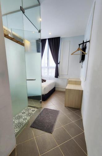 a bathroom with a walk in shower and a toilet at Mac Hotel by Sky Hive in George Town
