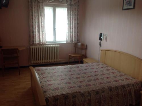 A bed or beds in a room at Relais Vosges Alsace