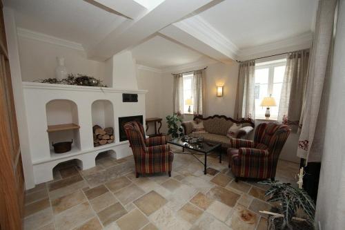 a living room with a couch and chairs and a fireplace at Landhotel - Hotel & Brauereigasthof Schneider in Essing