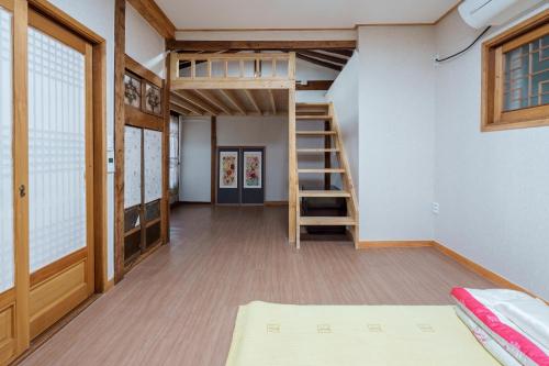 a room with a bunk bed and a staircase at Aega Hanok Guesthouse in Daegu