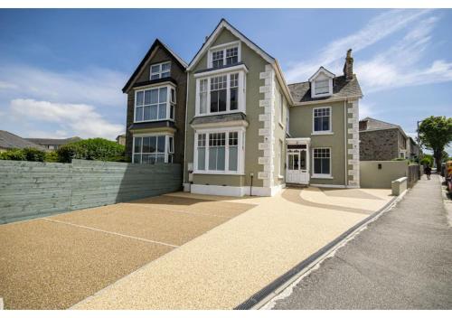 a large house with a fence in front of it at ALTIDO House in Camborne, Cornwall in Camborne