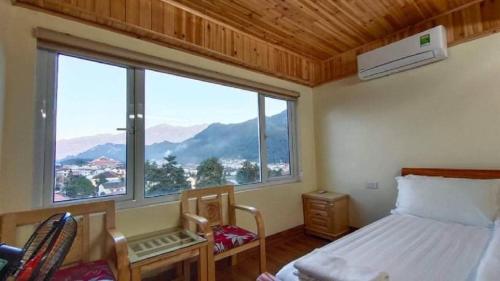 a bedroom with a bed and a large window at Venus Sapa Hostel in Sa Pa