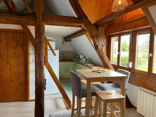 a kitchen and dining room with a table and chairs at L'atypique au pays de Honfleur in Genneville