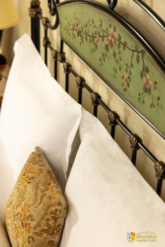 a close up of a bed with pillows at Arkefthos Mountain Hotel in Papigko