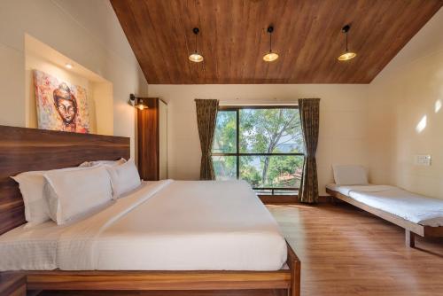 a bedroom with a large bed and a window at SaffronStays Casa Tranquil, Panchgani - pet-friendly veg only pool villa in Panchgani