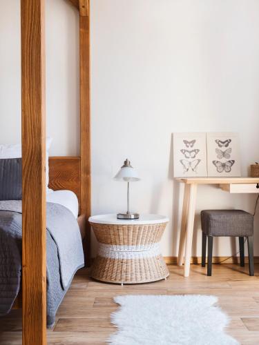 a bedroom with a bed and a table at Anděl Penzion & Cafe in Rožnov pod Radhoštěm