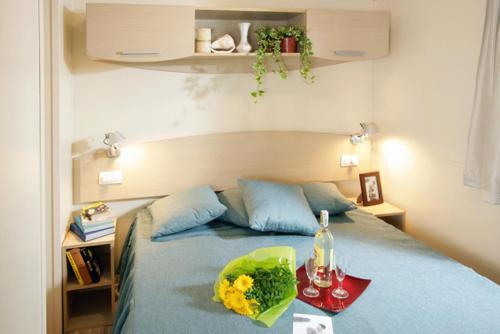 a bedroom with a bed with a tray of food on it at Casa mobile - Bella Austria**** in Sankt Peter am Kammersberg